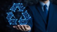 Asian businessman in suit holding glowing blue recycling symbol made of connected dots and lines, representing sustainability and environmental technology.