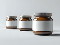 Glass jars with chocolate spread and blank white labels on gray background, mockup for branding and packaging design presentation in minimal style.
