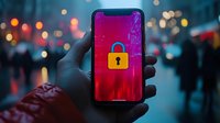 Smartphone displaying security lock icon on red screen against blurred city lights background, demonstrating mobile data protection and cybersecurity concept.