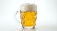 Mug of golden lager beer with thick foam head and condensation droplets, isolated on white background for beverage and food industry use.