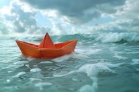 Orange paper boat floating on stormy sea water with dramatic cloudy sky, concept of hope, survival and journey through challenges, perfect for business metaphor.
