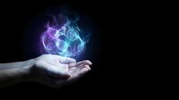 Human hands cupping glowing energy orb with swirling purple and blue flames against black background for spiritual healing and magic concepts.
