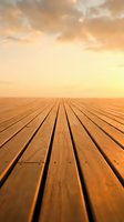 Wooden deck platform with warm sunset sky background for product display and presentation purposes.