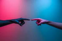 Two hands reaching toward each other with pointing fingers against vibrant pink and blue gradient background for connection and communication concepts.