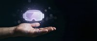 Man's hand holding glowing virtual reality headset with digital light effects and bokeh on dark background for technology and innovation concepts.