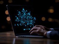 Glowing network tree diagram on laptop screen with businessman hand typing in dark office, representing digital transformation and connectivity.