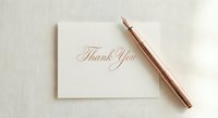 Elegant thank you card with rose gold pen on neutral background for wedding stationery and formal correspondence design.
