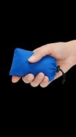 Hand holding a compact blue drawstring pouch, isolated on transparent background. Great for travel gear clipart, stickers, print on demand, and t-shirt design use.