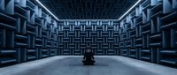 Modern anechoic chamber with geometric foam panels and single chair for acoustic testing, sound isolation, and audio engineering research applications.