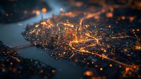 Aerial night cityscape with glowing orange lights and river dividing urban landscape, creating abstract tilt-shift effect with bokeh illumination. Suitable for urban planning.