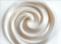 Smooth swirling cream texture in soft beige and white tones creates abstract spiral pattern with gentle gradient effect, suitable for food and cosmetic designs.