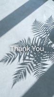 Thank you card with fern leaf shadows on a light concrete surface, minimal aesthetic with elegant white text for social media and greeting use.