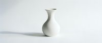 Elegant white ceramic vase with narrow neck isolated on light background, suitable for home decor, interior design, and product styling projects.
