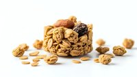 Mixed nuts and dried fruits in wicker basket on white background. Healthy snacking, organic food ingredients for cooking and baking recipes.