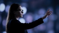 Professional businesswoman with glasses pointing forward in modern office environment with bokeh lights background for corporate presentations.