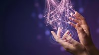 Hands holding glowing digital network connections and data streams against purple background, representing technology, communication, and innovation in business.