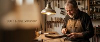 Senior craftsman woodworker with beard working on wooden project in traditional workshop with vintage tools and warm lighting for artisan content.