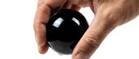 Hand holding glossy black sphere ball isolated on white background for design projects and creative concepts.