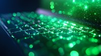 Illuminated computer keyboard with vibrant green bokeh lights and glowing particles creating magical tech atmosphere, close-up view for technology concepts.