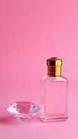 Luxury perfume bottle with golden cap and crystal diamond on pink background for cosmetics and fragrance branding.