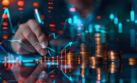 Financial analyst working with market data and stacks of coins, blue and red trading charts overlay, dramatic lighting creates modern investment atmosphere.