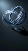 Glowing blue energy rings floating above open hand in dark atmospheric setting for technology and innovation concepts.