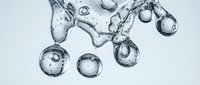 Clear water splash with bubbles and droplets on white background for refreshing beverage and hydration concepts in commercial design projects.
