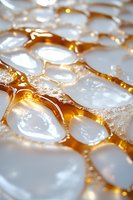 Fresh honeycomb cells filled with raw honey and white wax caps, macro photography showing natural hexagonal pattern and golden amber liquid.