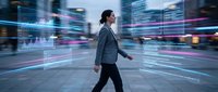 Professional businesswoman walking through futuristic digital city with motion blur lights and data streams representing modern technology and innovation.