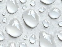 Pure water drops of various sizes on light gray surface creating natural abstract pattern with reflections and highlights for fresh clean backgrounds.