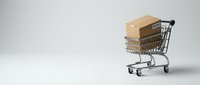 Shopping cart filled with stacked cardboard boxes on white background, representing e-commerce, online shopping, delivery services, and retail logistics.
