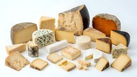 Assorted gourmet cheese collection featuring aged cheddar, blue cheese, brie, gouda and artisanal varieties on white background for culinary design.