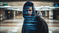 Young African American man in hooded sweatshirt standing in underground passage with creative blue light stripes effect across face creating mysterious atmosphere.