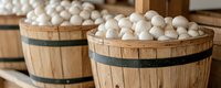 Fresh white mushrooms in rustic wooden barrels at farmers market, panoramic view showing natural organic produce in traditional harvest baskets.