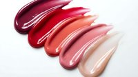 Colorful lipstick swatches in burgundy red pink nude shades smeared on white background for cosmetics makeup beauty products advertising campaigns.