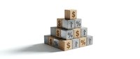 Wooden blocks stacked in pyramid formation displaying dollar signs and percentage symbols representing financial growth and investment concepts.