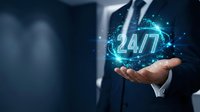 Businessman holding glowing 24/7 hologram in palm representing round-the-clock customer service and continuous business operations support.