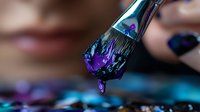 Macro shot of makeup brush with purple liquid paint dripping, artistic cosmetic concept with vibrant colors against dark background. Professional beauty supplies.