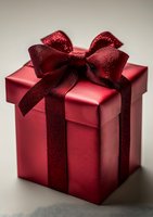 Elegant red gift box with shimmering burgundy ribbon bow on neutral background, perfect for holiday, valentine, or anniversary celebration designs.