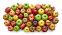 Assorted fresh apples in red, green, and yellow varieties arranged on white background, isolated for food and grocery design use.