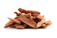 Pile of dried sandalwood chunks and pieces isolated on white background, aromatic natural material used in traditional medicine and fragrance industry.