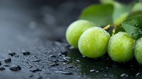 Fresh green grapes with water drops on dark background, macro shot showing juicy texture and natural moisture for gourmet food photography.