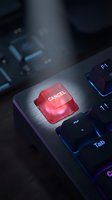 Red cancel button on computer keyboard with dramatic lighting for technology and business concepts.