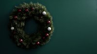 Festive pine wreath decorated with red and white ornaments against dark green wall, creating elegant holiday atmosphere for Christmas decor.