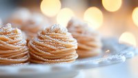 Fresh mont blanc desserts with whipped cream swirls dusted with powdered sugar against soft bokeh lights, creating an elegant patisserie atmosphere.