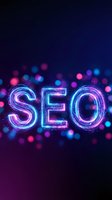 Glowing neon SEO letters with colorful bokeh lights on dark background for digital marketing and search engine optimization concepts.
