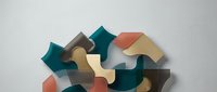 Abstract geometric composition with overlapping curved and angular shapes in teal, coral, beige, and gray tones creating modern artistic design.
