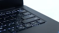 Close-up of black laptop keyboard with shallow depth of field, showing keys in focus for technology, computing, typing, and office work concepts.