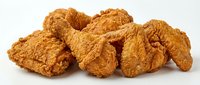 Crispy golden fried chicken pieces isolated on white background, ready for food packaging, restaurant menus, and culinary design projects.