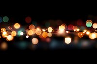 Defocused multicolored bokeh lights creating magical atmosphere on black background, festive glowing circles pattern for holiday and celebration designs.